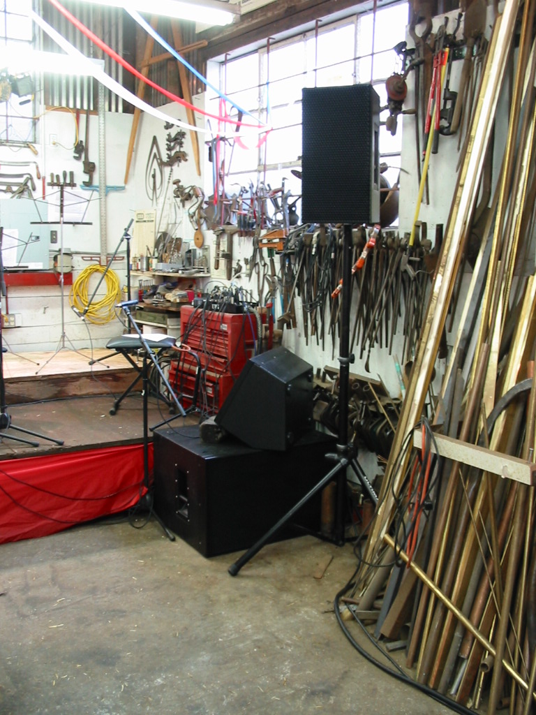 QSC K12.2 pair with stands and mixer — view 2