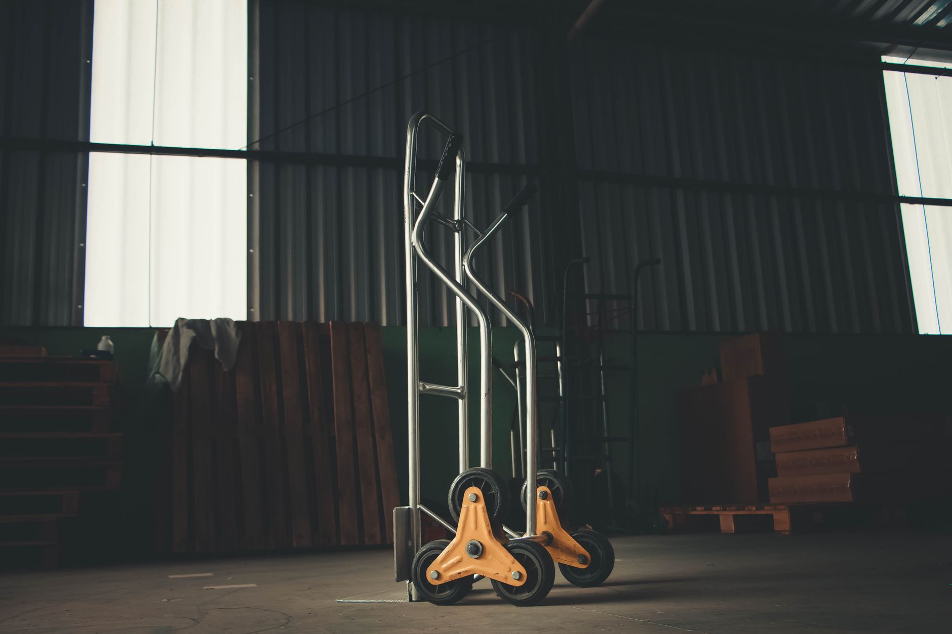 Pallet jack and two furniture dollies — view 1